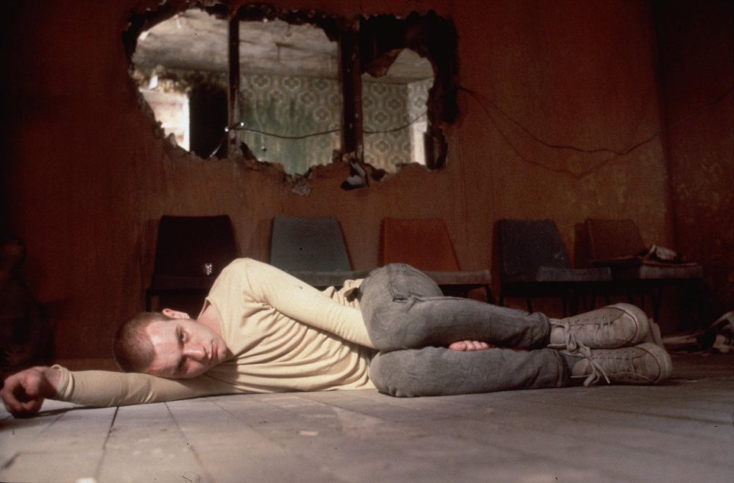 Ewan McGregor as Mark Renton laying on the floor in Trainspotting
